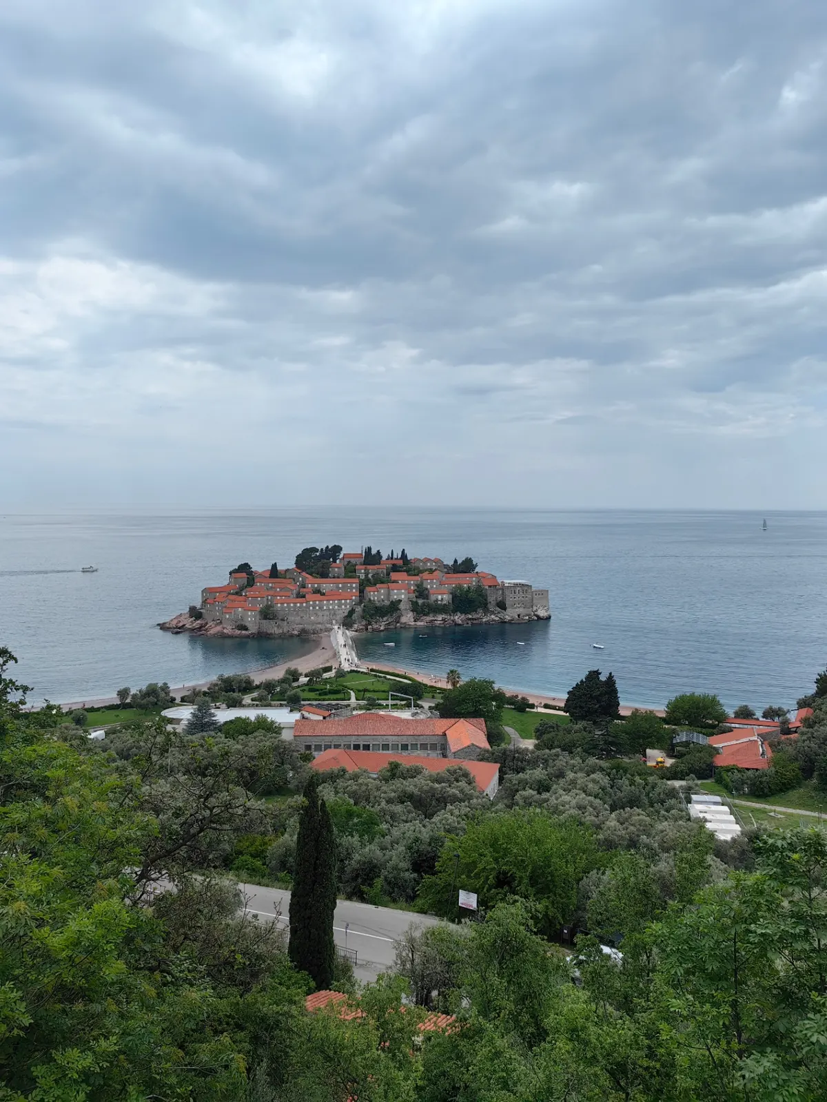 Sveti Stefan island and shoreline on a cloudy day