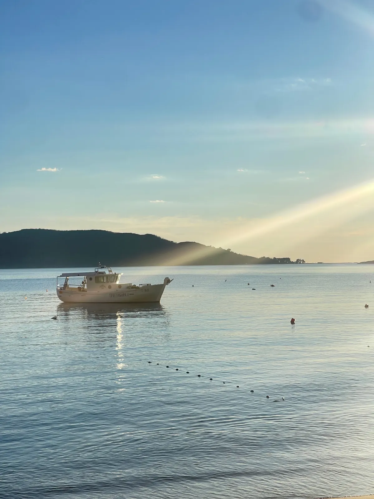 Small fishing boat on a calm Adriatic sea at sunset