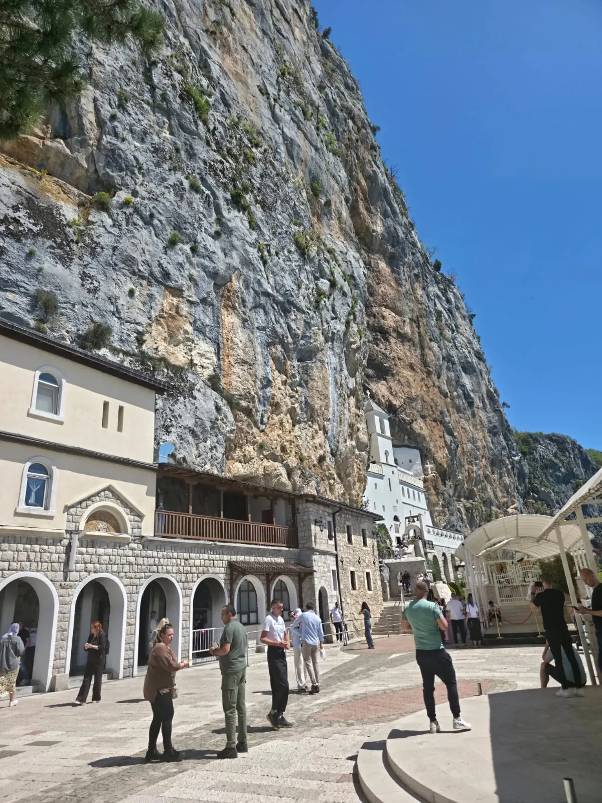 Ostrog Monastery courtyard beneath the cliff